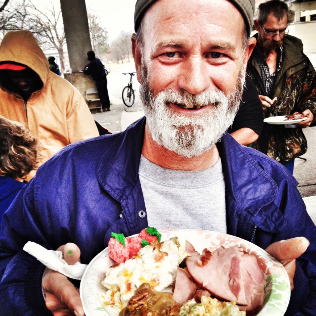 homeless man with plate of christmas dinner, under the bridge, feeding the homeless